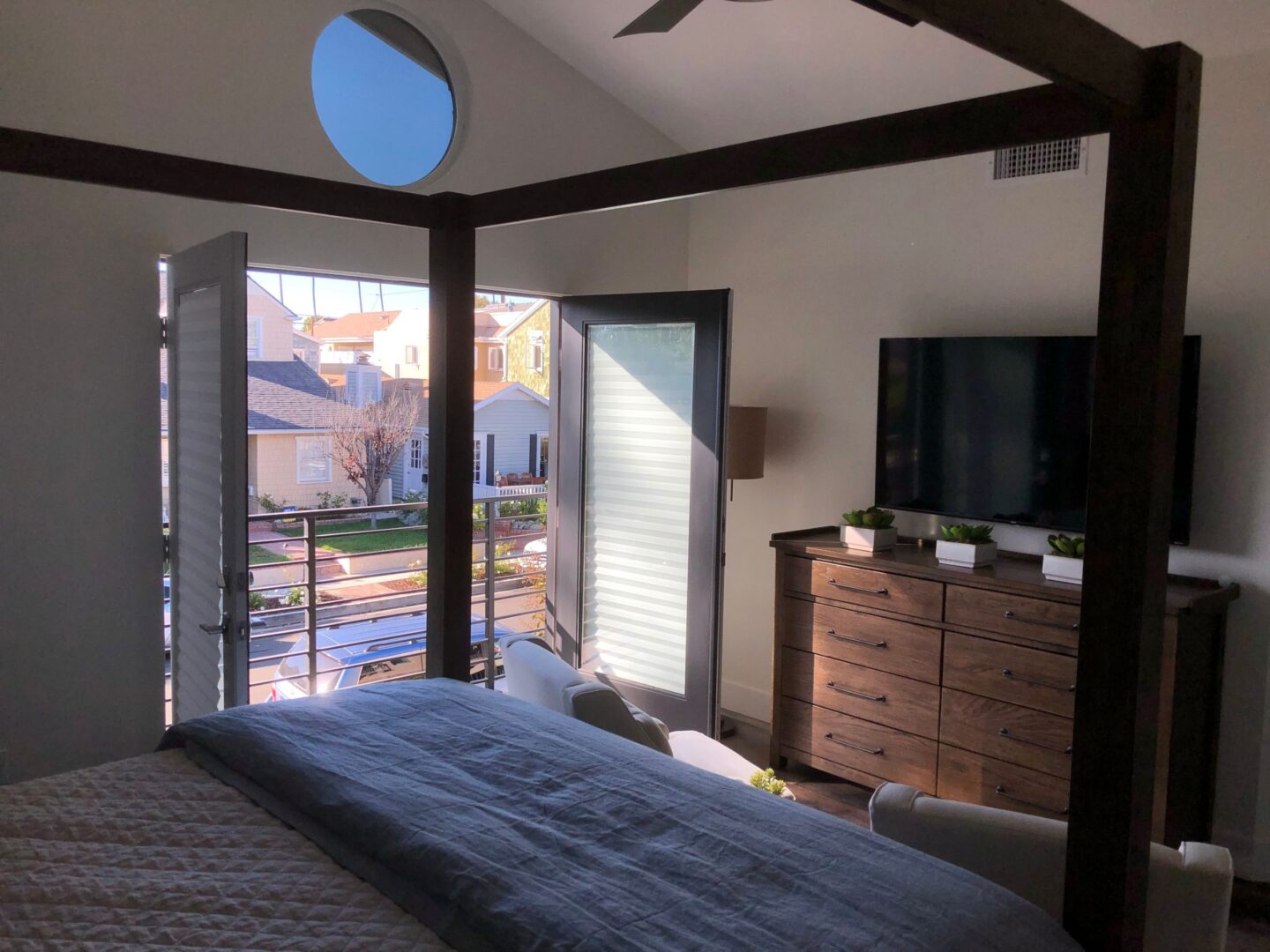 A bedroom with a door to a balcony
